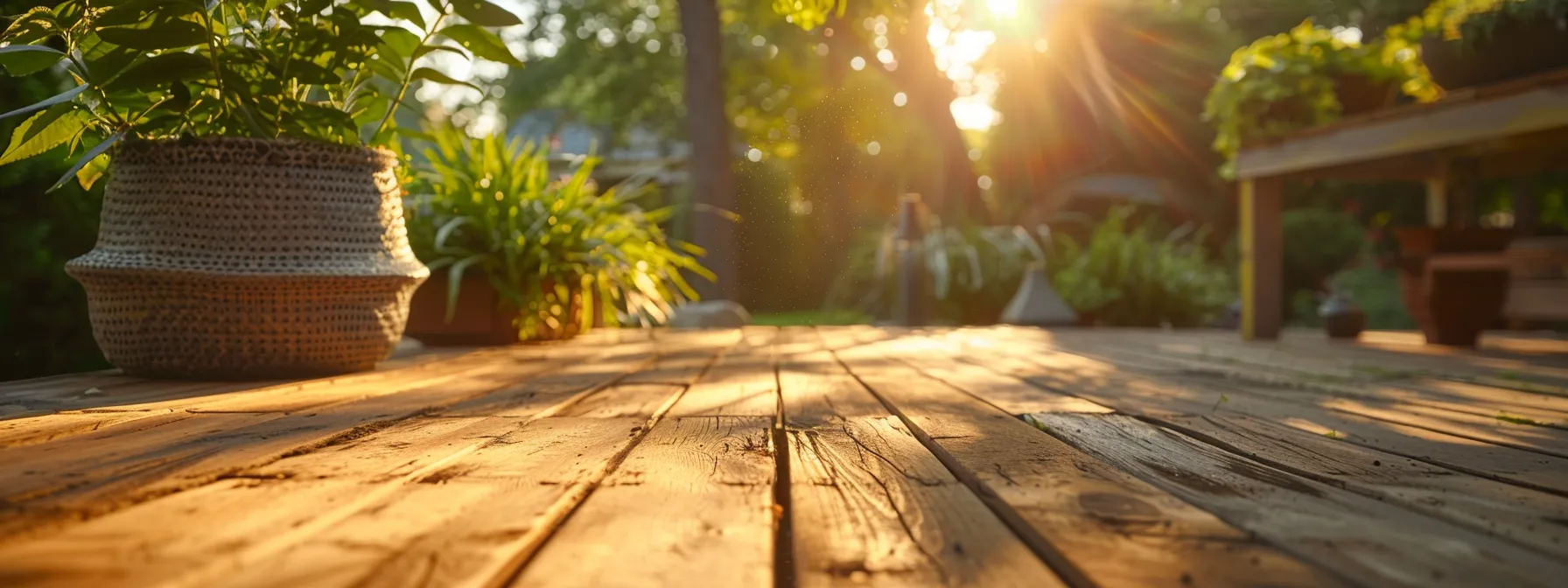 a beautifully crafted wooden deck, basking in golden sunlight, showcases a seamless blend of quality craftsmanship and natural surroundings in a serene des moines backyard.