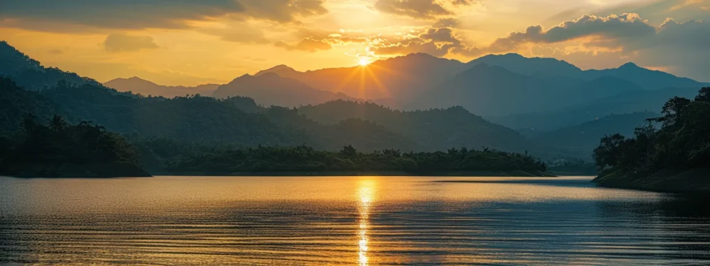 a breathtaking sunset casts a warm, golden glow over a tranquil lake, surrounded by lush greenery and silhouetted mountains, capturing a serene moment of natural beauty.